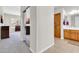 Hallway with a tile floor leading to a bathroom, and a mirrored closet door at 20423 S 186Th St, Queen Creek, AZ 85142