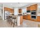 Spacious kitchen with stainless steel appliances, center island with seating, and ample cabinetry at 20423 S 186Th St, Queen Creek, AZ 85142