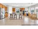 A spacious kitchen with wooden cabinets, a large center island with bar seating, and stainless steel appliances at 20423 S 186Th St, Queen Creek, AZ 85142