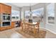 This dining area features a wooden table, chairs, and large windows that provide plenty of natural light at 20423 S 186Th St, Queen Creek, AZ 85142