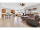 An open-concept living space boasts a kitchen, dining area, and living room with comfortable furnishings at 20423 S 186Th St, Queen Creek, AZ 85142