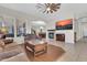 The living room features neutral walls, recessed lighting, a ceiling fan, and comfortable seating furniture at 20423 S 186Th St, Queen Creek, AZ 85142
