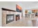 An open living area features a fireplace and seamlessly connects to the kitchen and dining space at 20423 S 186Th St, Queen Creek, AZ 85142