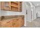 A pantry with wooden cabinets and granite countertops provides ample storage space at 20423 S 186Th St, Queen Creek, AZ 85142