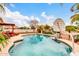 A refreshing pool with a basketball hoop and rock feature offers hours of enjoyment, set against a sunny backyard landscape at 20423 S 186Th St, Queen Creek, AZ 85142