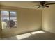 Well-lit bedroom with a ceiling fan, a window view of a car, and tile flooring at 2100 W Lemon Tree Pl # 29, Chandler, AZ 85224