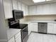Well-lit kitchen featuring stainless steel appliances, white countertops and cabinetry at 2100 W Lemon Tree Pl # 29, Chandler, AZ 85224