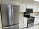 Modern kitchen with stainless steel appliances and white cabinetry at 2100 W Lemon Tree Pl # 29, Chandler, AZ 85224