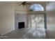 Bright living room with a fireplace, tile floors, a ceiling fan, and a large window at 2100 W Lemon Tree Pl # 29, Chandler, AZ 85224