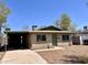 Charming single-story home featuring a covered carport, neutral brick, and a well-kept front yard at 2134 E Harvard St, Phoenix, AZ 85006