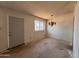 Spacious room with a vintage chandelier and a bright window at 2134 E Harvard St, Phoenix, AZ 85006