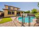 Backyard pool with safety fence and two-story home create outdoor enjoyment at 22184 N 101St Dr, Peoria, AZ 85383
