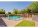 Backyard pool with safety fence, rock landscaping and artificial turf at 22184 N 101St Dr, Peoria, AZ 85383