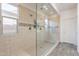 Bathroom shower features stone floors, glass door, window, and multiple shower heads at 22184 N 101St Dr, Peoria, AZ 85383