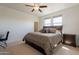 Bedroom featuring a ceiling fan, dresser and lots of natural light at 22184 N 101St Dr, Peoria, AZ 85383