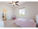 Bright bedroom with a cozy bed, large windows, and an ensuite bathroom at 22184 N 101St Dr, Peoria, AZ 85383