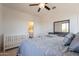 Bedroom with a crib and a view of the bathroom at 22184 N 101St Dr, Peoria, AZ 85383