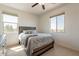 Well-lit bedroom featuring neutral color palette, two windows, and cozy decor at 22184 N 101St Dr, Peoria, AZ 85383
