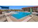 Inviting community pool area with seating, umbrellas, and clear blue water at 22184 N 101St Dr, Peoria, AZ 85383