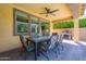 Covered patio is perfect for dining outdoors, with a ceiling fan and grill at 22184 N 101St Dr, Peoria, AZ 85383