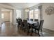 The dining area has a large window, a modern light fixture, and enough room for eight chairs at 22184 N 101St Dr, Peoria, AZ 85383