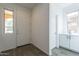 Inviting foyer featuring neutral walls, wood look tile flooring, and a bright white door at 22184 N 101St Dr, Peoria, AZ 85383