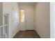 Bright foyer with wood look tile flooring, featuring a white door and staircase at 22184 N 101St Dr, Peoria, AZ 85383