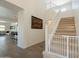 Open foyer with staircase and baby gate, seamlessly connecting to the living area at 22184 N 101St Dr, Peoria, AZ 85383