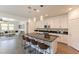 Kitchen with a large island, stainless steel appliances, and pendant lighting with views of the living room at 22184 N 101St Dr, Peoria, AZ 85383