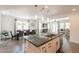 This modern kitchen boasts an island, stainless steel appliances, and pendant lighting at 22184 N 101St Dr, Peoria, AZ 85383