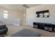 Bright living room with comfortable seating, a television, and stairs leading to another level at 22184 N 101St Dr, Peoria, AZ 85383