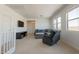 Cozy living room with comfortable seating, a television, and plenty of natural light from the windows at 22184 N 101St Dr, Peoria, AZ 85383