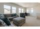 Bright living room with comfortable seating, large windows, and a desk area at 22184 N 101St Dr, Peoria, AZ 85383