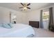 Airy main bedroom features a ceiling fan and en-suite bathroom with a large shower at 22184 N 101St Dr, Peoria, AZ 85383
