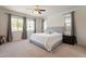 Light-filled bedroom with neutral tones, soft carpet, and large windows at 22184 N 101St Dr, Peoria, AZ 85383