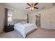 Spacious primary bedroom with plush carpet, ceiling fan, and ample natural light at 22184 N 101St Dr, Peoria, AZ 85383