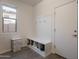 Mud room features a bench with shoe storage, hooks, and neutral tones at 22184 N 101St Dr, Peoria, AZ 85383