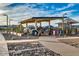 Modern community playground with shaded play structures and a surrounding walking path at 22184 N 101St Dr, Peoria, AZ 85383
