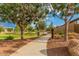 Community walking path with well-maintained landscaping and mature trees at 22184 N 101St Dr, Peoria, AZ 85383