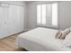 Inviting bedroom with shuttered windows, closet, and a comfortable bed, showcasing simplicity and elegance at 2363 Leisure World --, Mesa, AZ 85206