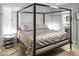 Comfortable bedroom with a four poster bed frame, alongside white shuttered windows and decor at 2363 Leisure World --, Mesa, AZ 85206