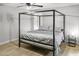 Spacious bedroom with a modern four poster bed frame, complemented by sleek, light floors at 2363 Leisure World --, Mesa, AZ 85206