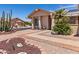 Attractive home exterior with desert landscaping, front flower garden, and a paved walkway at 2363 Leisure World --, Mesa, AZ 85206