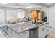 Bright kitchen with a granite island, stainless steel appliances, and an adjacent dining area at 2363 Leisure World --, Mesa, AZ 85206