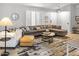 Cozy living room featuring a neutral sectional, large windows, and a stylish area rug at 2363 Leisure World --, Mesa, AZ 85206