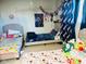 A bedroom showing three beds decorated with stuffed animals, character decor, and lots of color at 2377 W Hazelwood St, Phoenix, AZ 85015