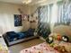 A bedroom showing beds with character decor, a window with curtains, and a ceiling fan at 2377 W Hazelwood St, Phoenix, AZ 85015
