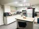 Functional kitchen with white cabinets, stainless steel appliances, and stylish countertops at 2377 W Hazelwood St, Phoenix, AZ 85015