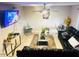 A living room featuring leather couches, decorative tables, plants, and tile flooring at 2377 W Hazelwood St, Phoenix, AZ 85015