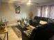 Inviting living room with comfortable leather seating and a stylish glass coffee table at 2377 W Hazelwood St, Phoenix, AZ 85015